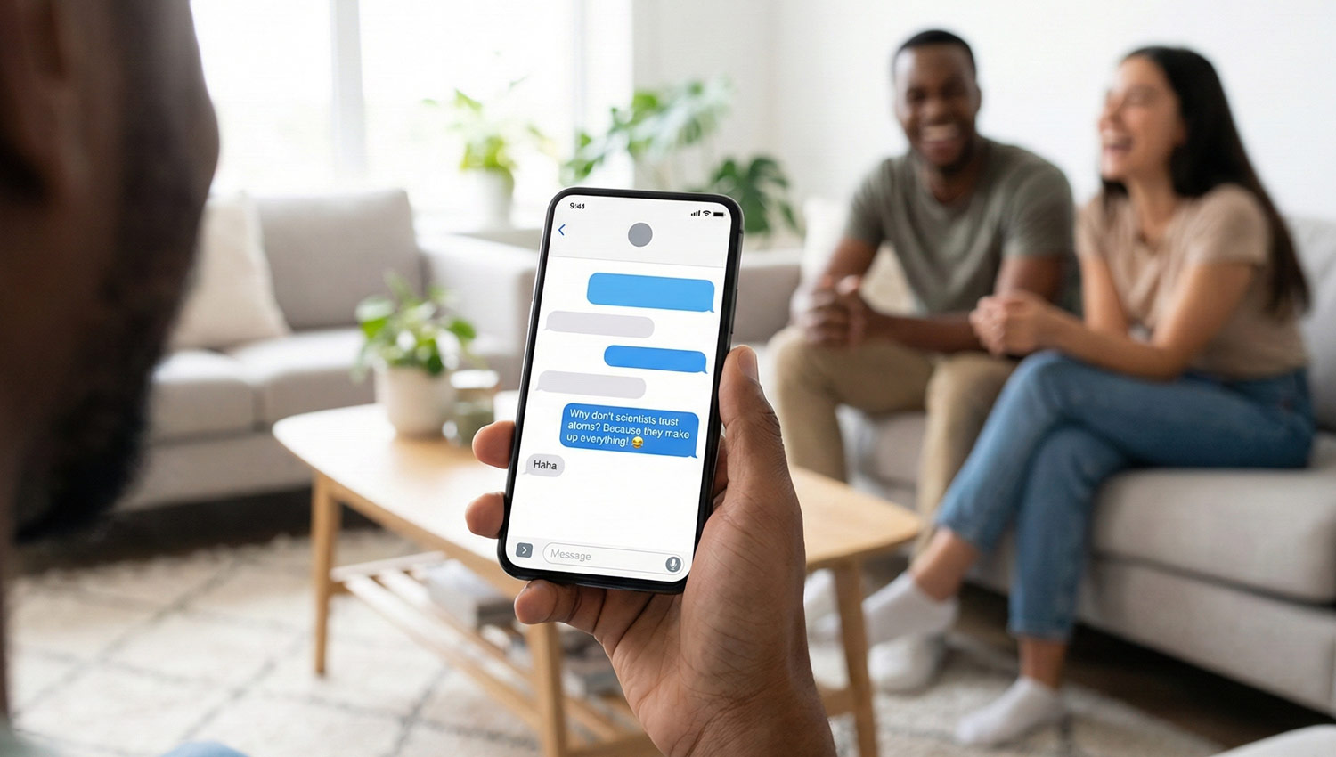 A person showing a dad joke on their phone while friends laugh