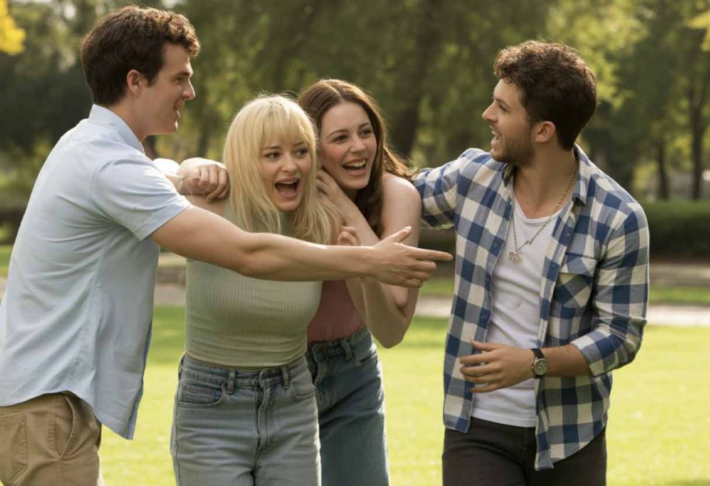 Friends acting out a funny scenario together in a park.