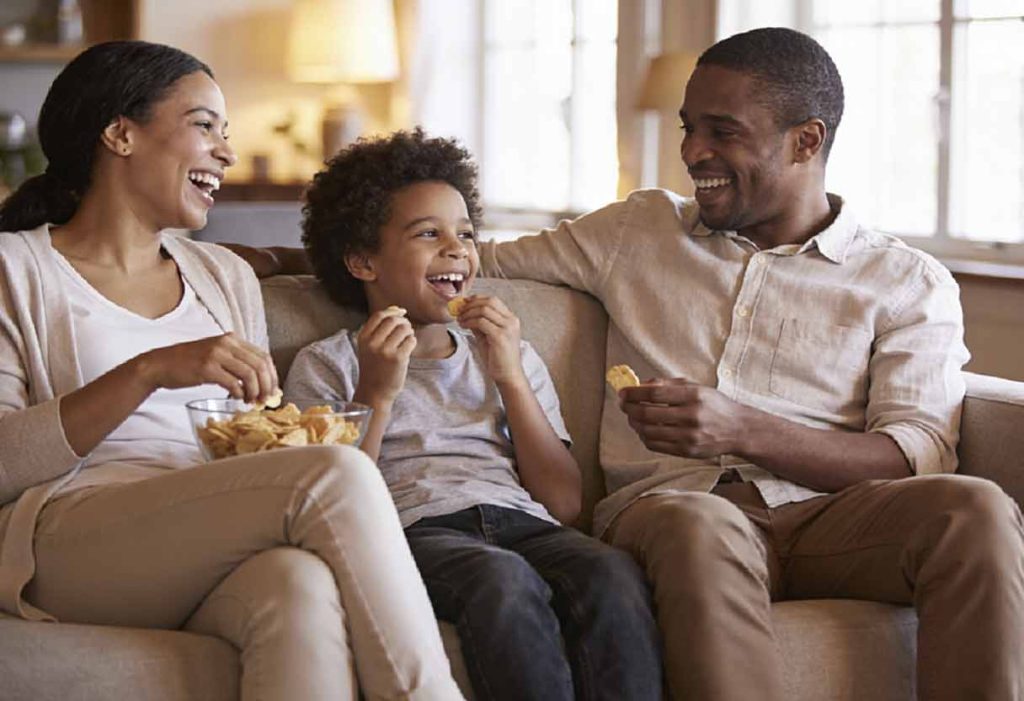 Family members laughing together at home during a casual evening